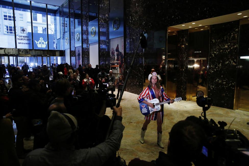 Robert Burck, known as the original "Naked Cowboy", sings inside the lobby at Trump Tower where U.S. President Elect Donald Trump lives in New York. REUTERS/Lucas Jackson